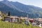 Panoramic view over Vervo village withÂ San Martino church, alpine slopes densely overgrown with evergreen forest